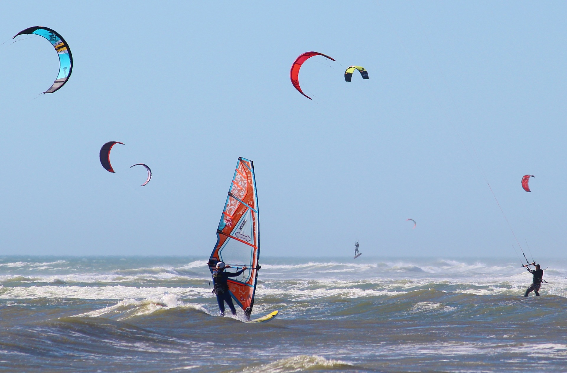 Kitesurfing - Kitesurfers surf across the ocean waves.